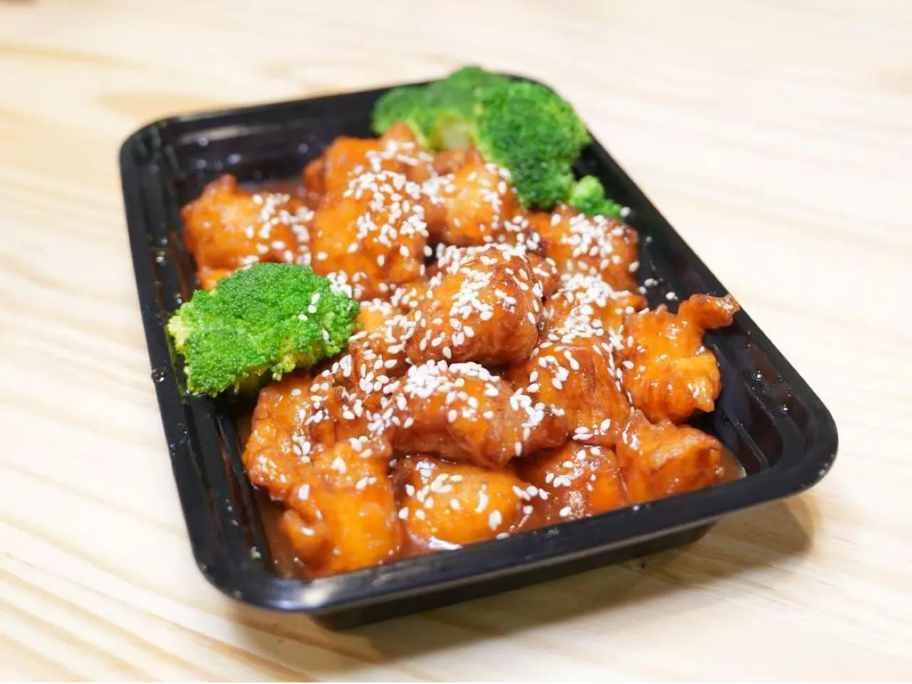 Crispy chicken in sweet sauce with sesame seeds at Insomnia Kitchen, a Chinese Restaurant in Houston